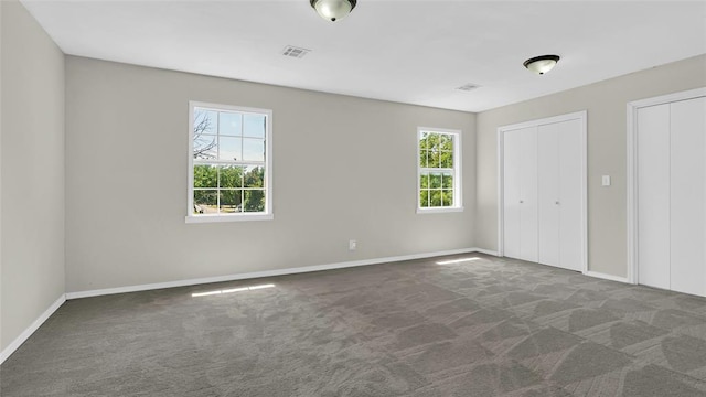 unfurnished bedroom featuring dark carpet