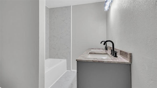 bathroom with a washtub and vanity