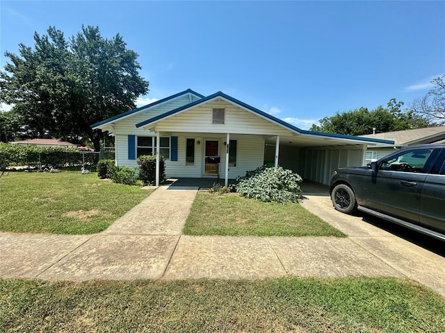 view of front facade with a carport, covered porch, and a front yard