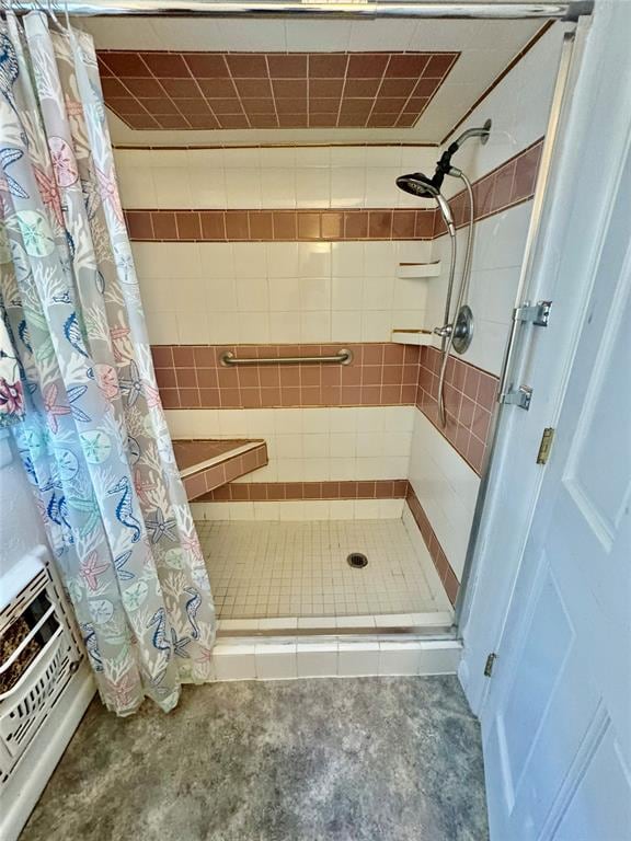 bathroom with concrete floors and a shower with shower curtain