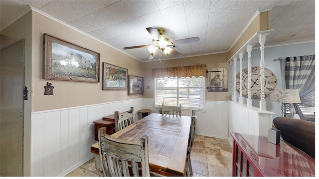 dining space featuring ceiling fan and ornamental molding