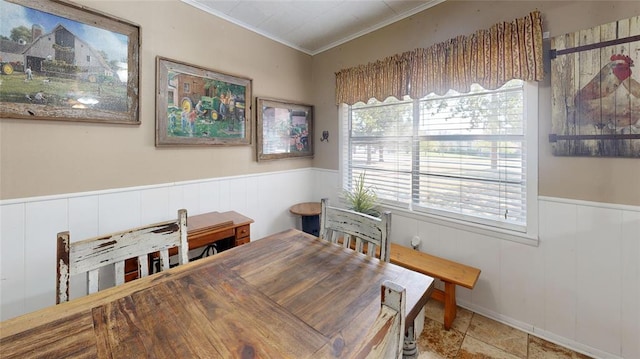 dining space featuring crown molding