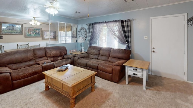 carpeted living room featuring ceiling fan and ornamental molding