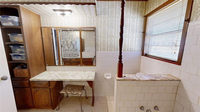 bathroom with tile patterned flooring and tile walls