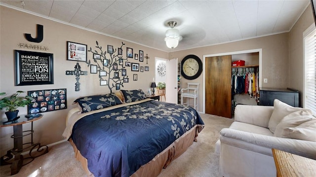 carpeted bedroom with crown molding and a closet