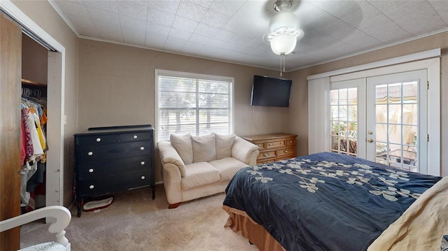 carpeted bedroom featuring french doors, crown molding, access to outside, and a closet