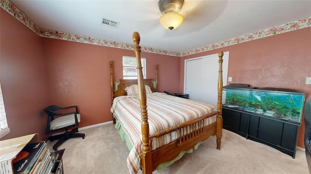 bedroom with light carpet, a closet, and ceiling fan