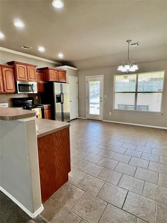 kitchen with kitchen peninsula, stainless steel appliances, crown molding, a notable chandelier, and hanging light fixtures