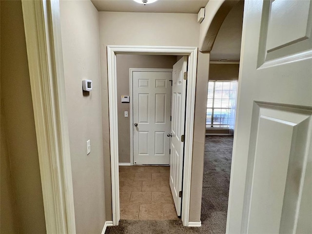 corridor featuring light colored carpet