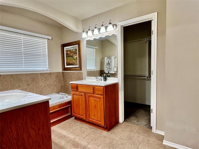 bathroom featuring tile patterned floors, vanity, and a bathing tub