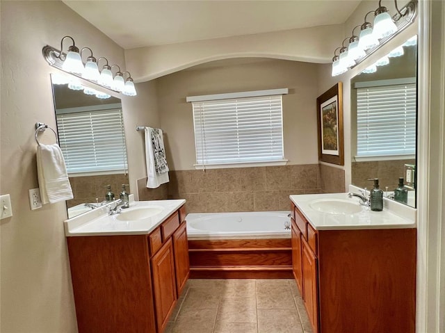 bathroom with vanity, tile patterned floors, and tiled tub