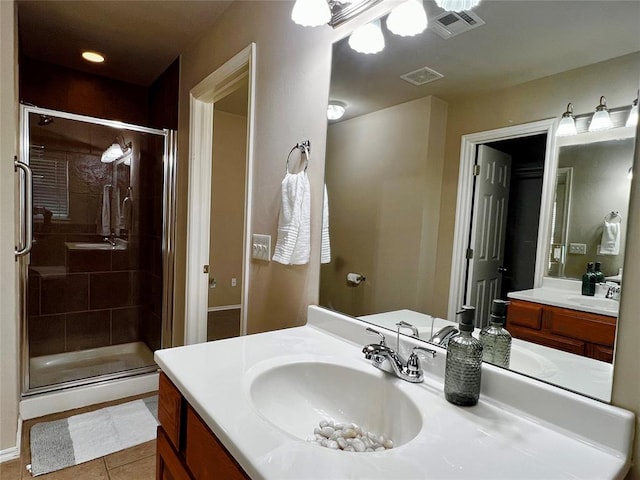 bathroom with tile patterned floors, vanity, and a shower with door