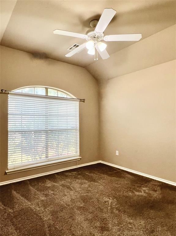 unfurnished room featuring ceiling fan, carpet floors, and vaulted ceiling