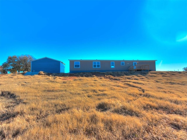 back of house featuring a rural view