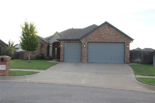 ranch-style house with a front lawn and a garage