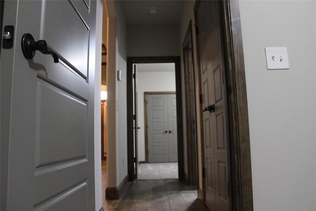 hallway with dark wood-type flooring