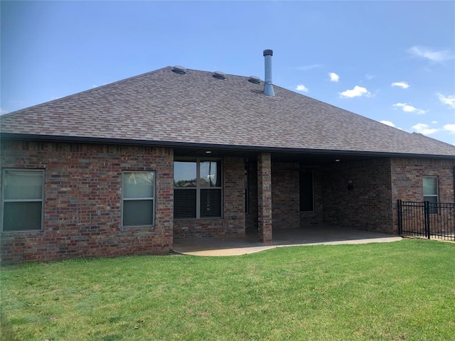 back of property featuring a yard and a patio