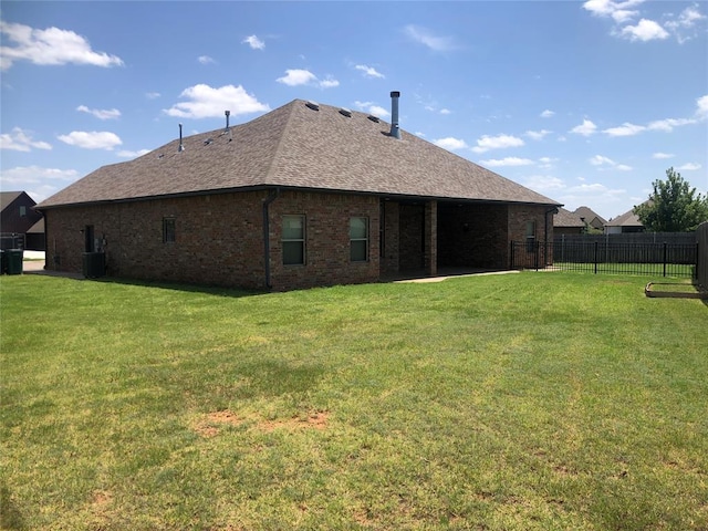 back of house with a lawn