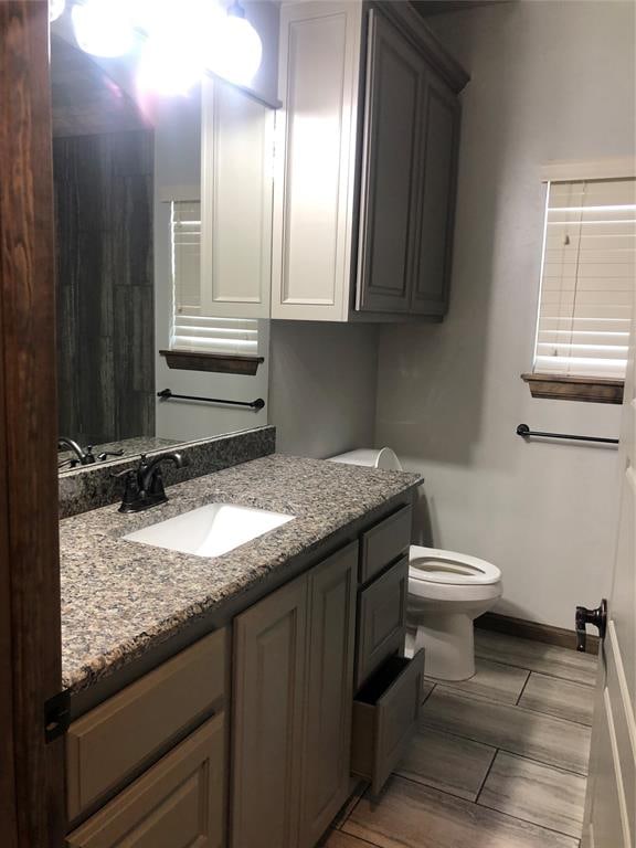 bathroom featuring vanity and toilet