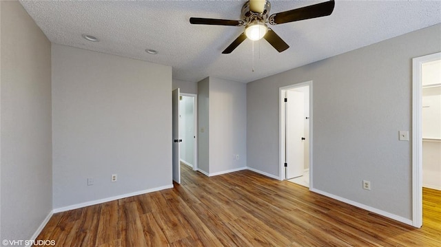 unfurnished bedroom featuring a textured ceiling, light hardwood / wood-style flooring, and ceiling fan