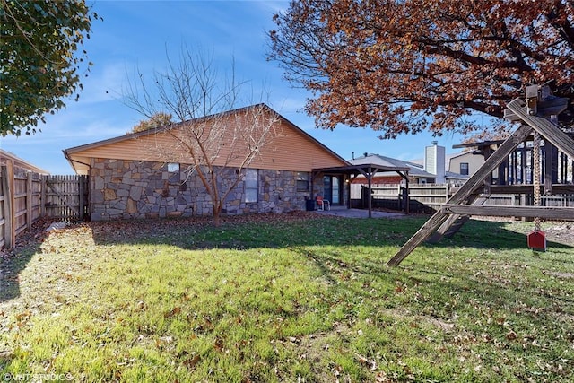 back of house featuring a gazebo and a lawn