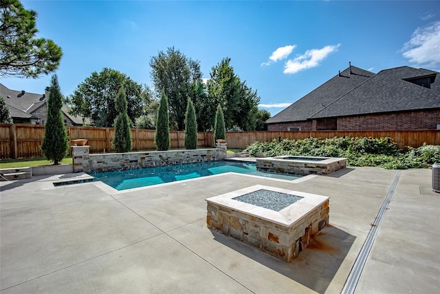 view of pool with a patio, an in ground hot tub, and an outdoor fire pit