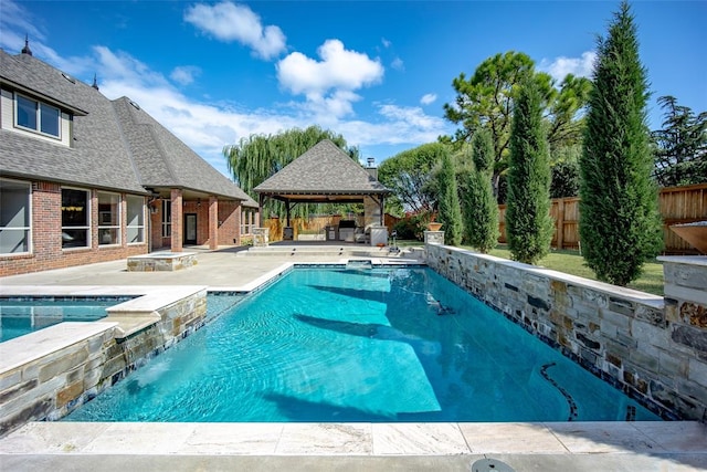 view of swimming pool featuring a gazebo, a patio area, an in ground hot tub, and pool water feature