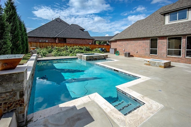 view of swimming pool with central AC unit, a patio area, and an in ground hot tub