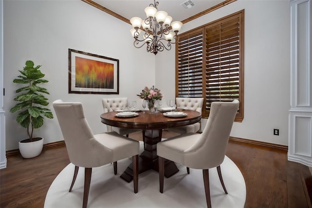 dining space with crown molding, dark wood-type flooring, and a chandelier