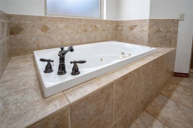 bathroom featuring tiled bath and tile patterned flooring