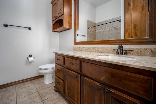 bathroom featuring toilet, vanity, and tile patterned floors