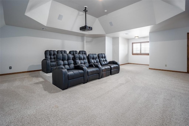 carpeted home theater room featuring vaulted ceiling