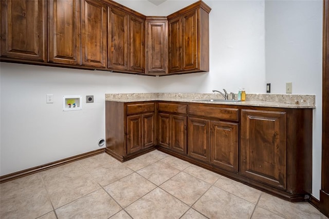 laundry room with electric dryer hookup, cabinets, sink, washer hookup, and light tile patterned floors