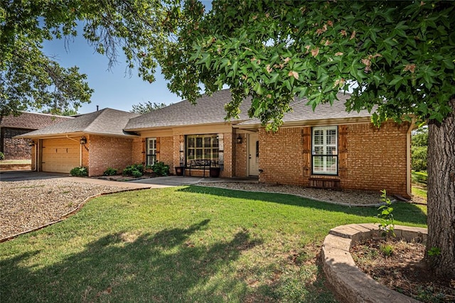 ranch-style home with a garage and a front lawn