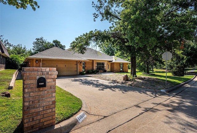 ranch-style house featuring a front yard and a garage