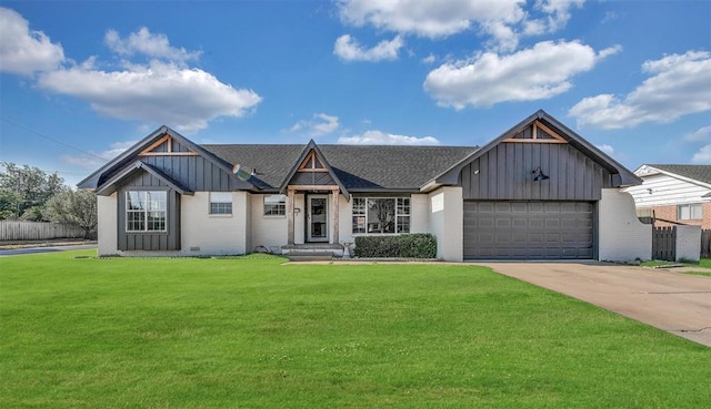 208 S Mockingbird Dr, Altus, OK 73521 - view of front of house with board and batten siding, an attached garage, a front yard, driveway, and brick siding