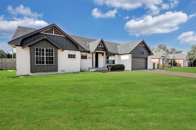 view of front of property featuring a garage and a front lawn