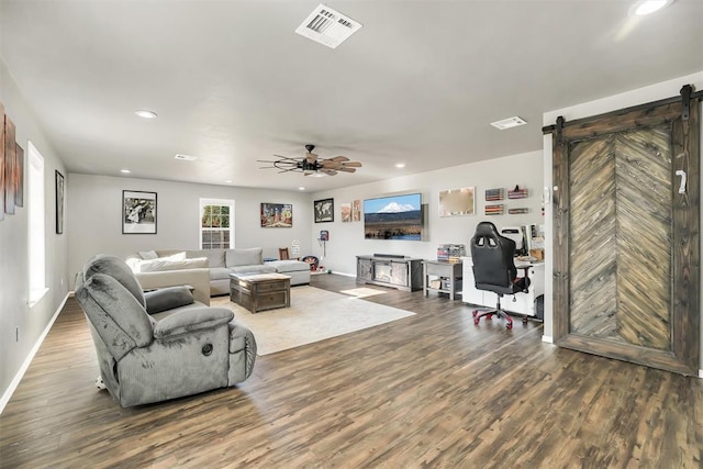 208 S Mockingbird Dr, Altus, OK 73521 - living room featuring a barn door, wood finished floors, recessed lighting, ceiling fan, and baseboards