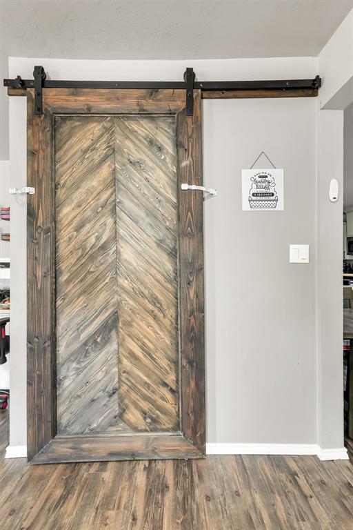 208 S Mockingbird Dr, Altus, OK 73521 - detailed view of a barn door and wood finished floors