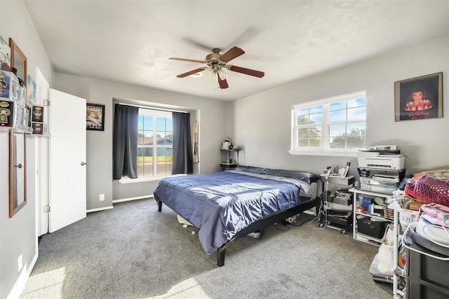 208 S Mockingbird Dr, Altus, OK 73521 - carpeted bedroom featuring multiple windows, ceiling fan, and baseboards