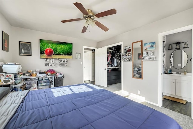208 S Mockingbird Dr, Altus, OK 73521 - bedroom featuring carpet floors, a ceiling fan, ensuite bathroom, a closet, and baseboards
