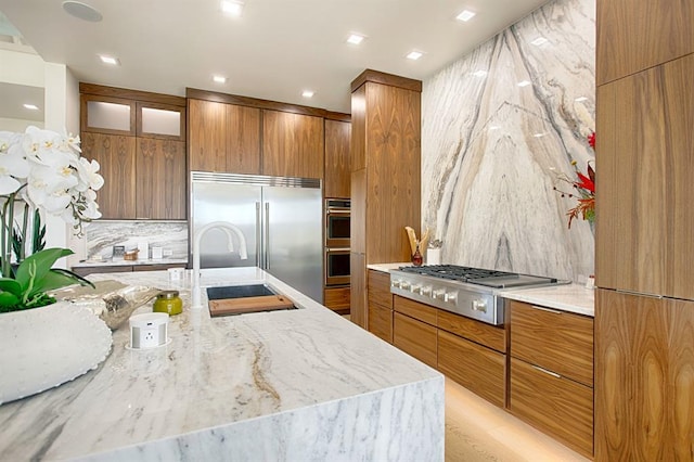 kitchen with appliances with stainless steel finishes, backsplash, and sink