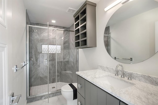 bathroom with vanity, toilet, and an enclosed shower