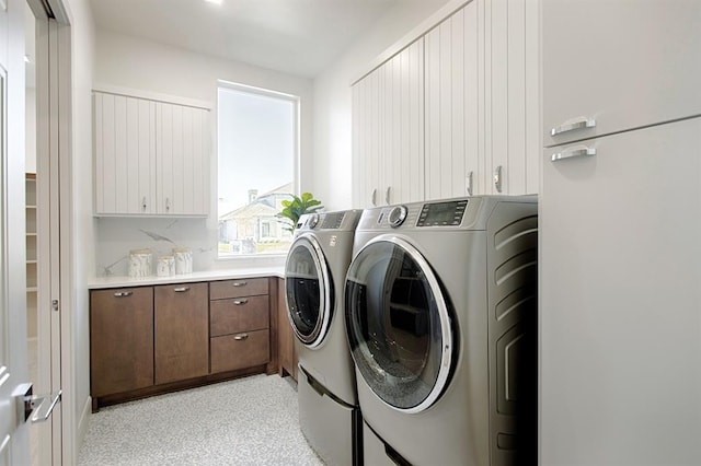 laundry area featuring cabinets and washer and dryer