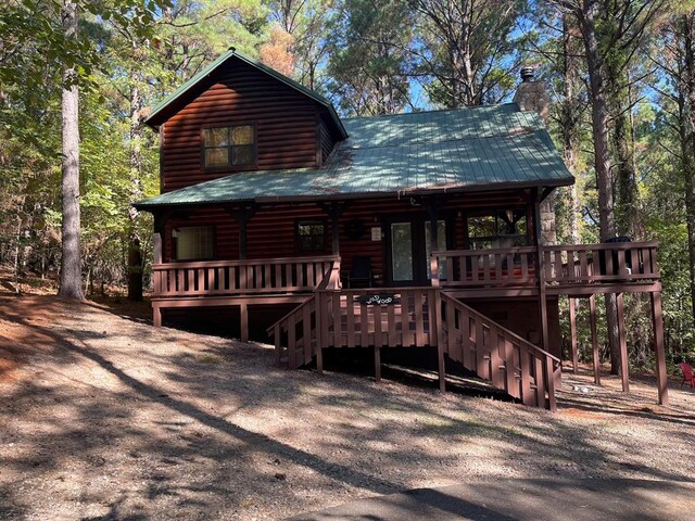 log cabin with a wooden deck