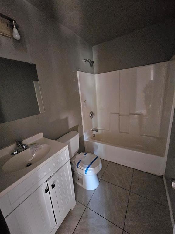 full bathroom with tile patterned flooring, vanity, bathing tub / shower combination, and toilet