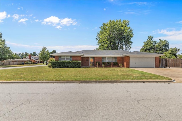 ranch-style home with a garage and a front lawn