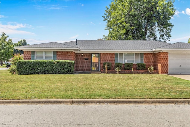 single story home featuring a front lawn and a garage