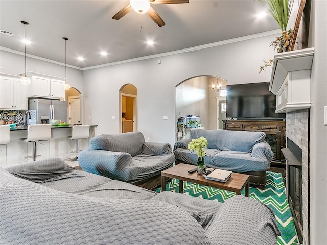 1301 Atalon Dr, Moore, OK 73160 - living area featuring arched walkways, ceiling fan, ornamental molding, and recessed lighting