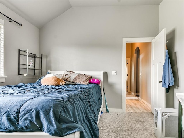 1301 Atalon Dr, Moore, OK 73160 - carpeted bedroom featuring lofted ceiling and arched walkways